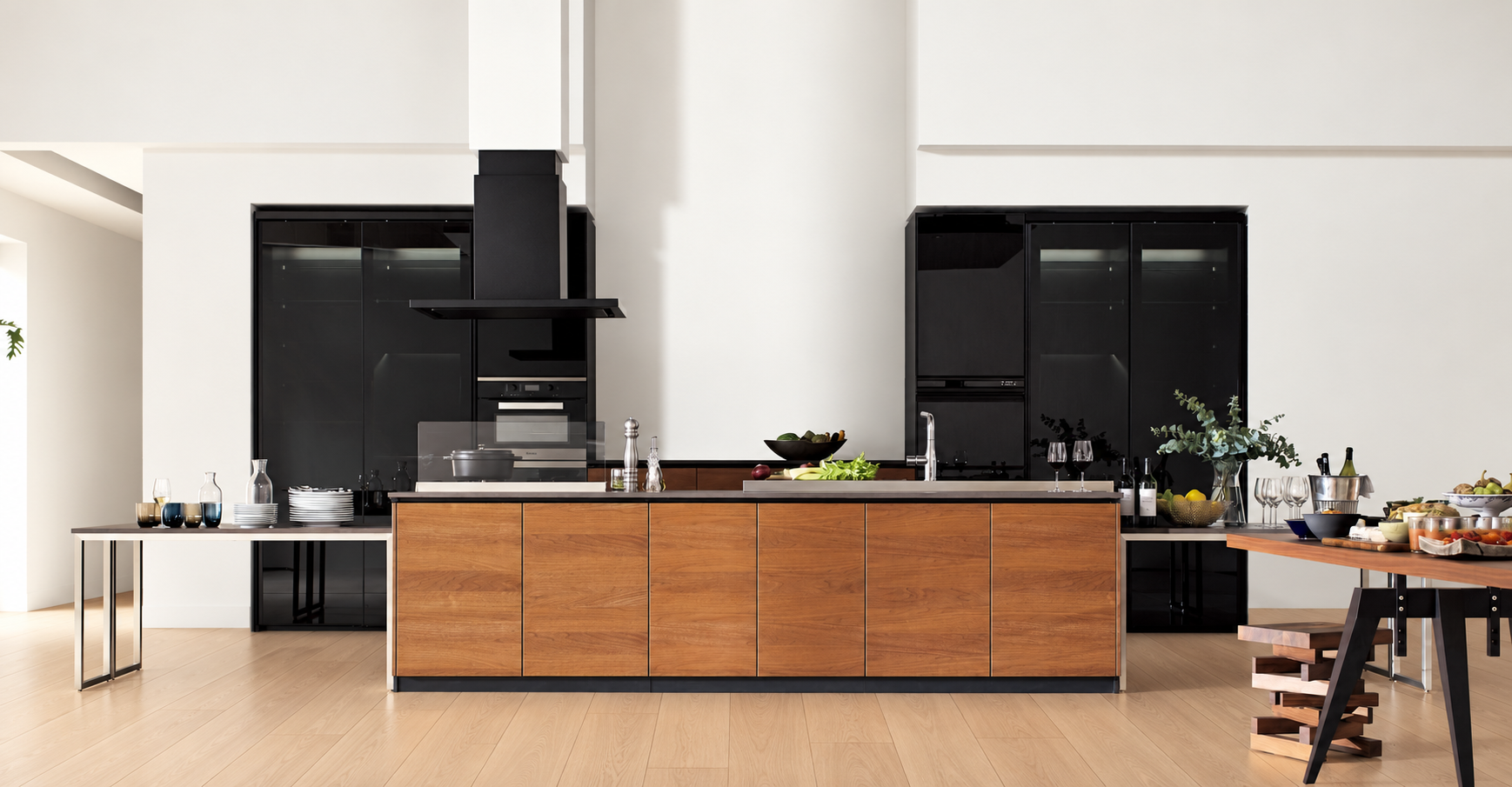 Kitchen with wood cabinetry and pale oak flooring