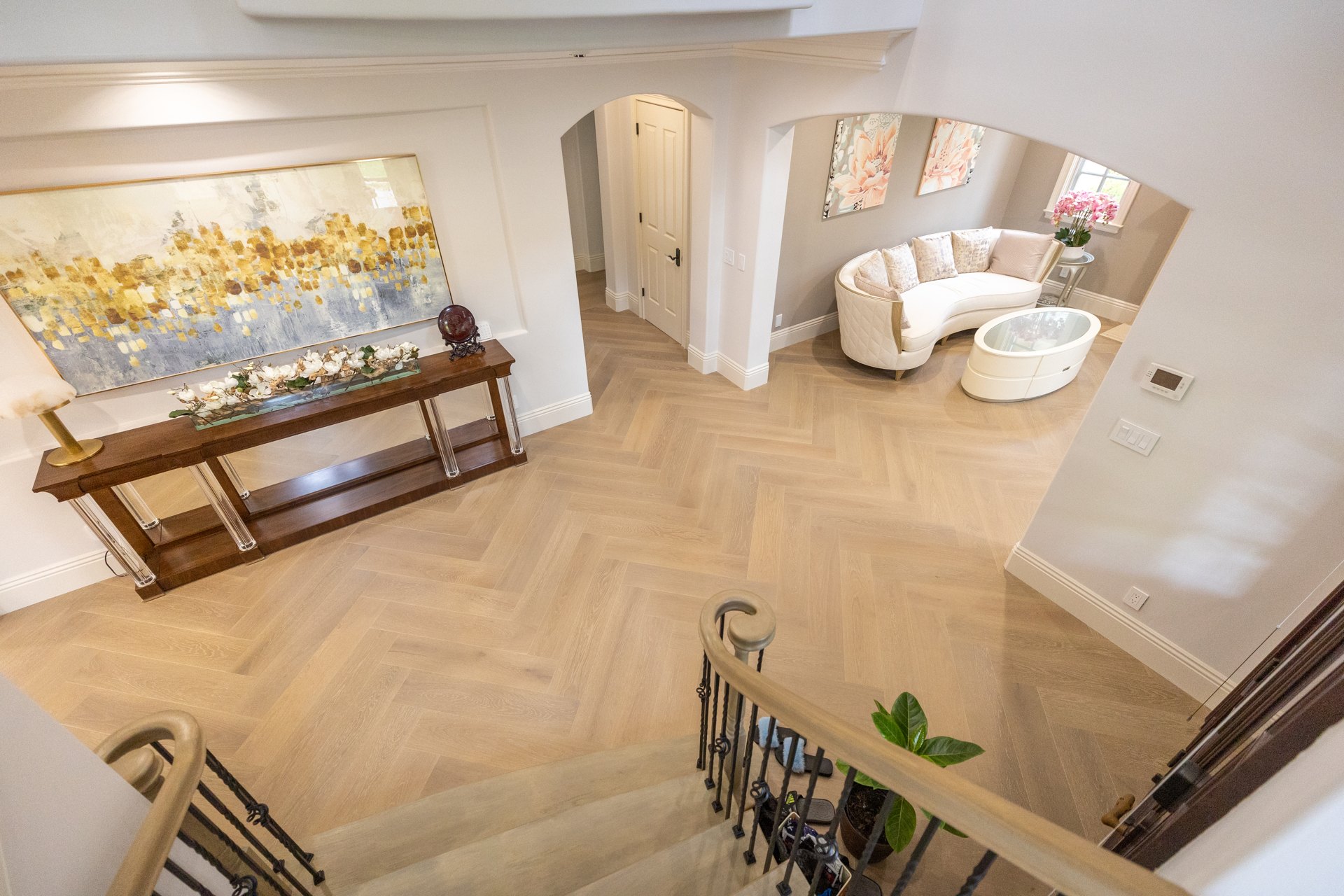 Herringbone flooring connecting entry and sitting room