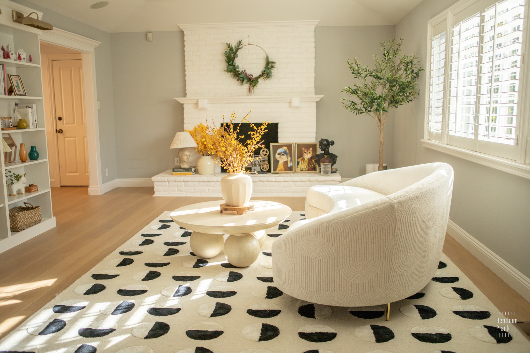 Royalwood project living room with pale flooring and curved seating